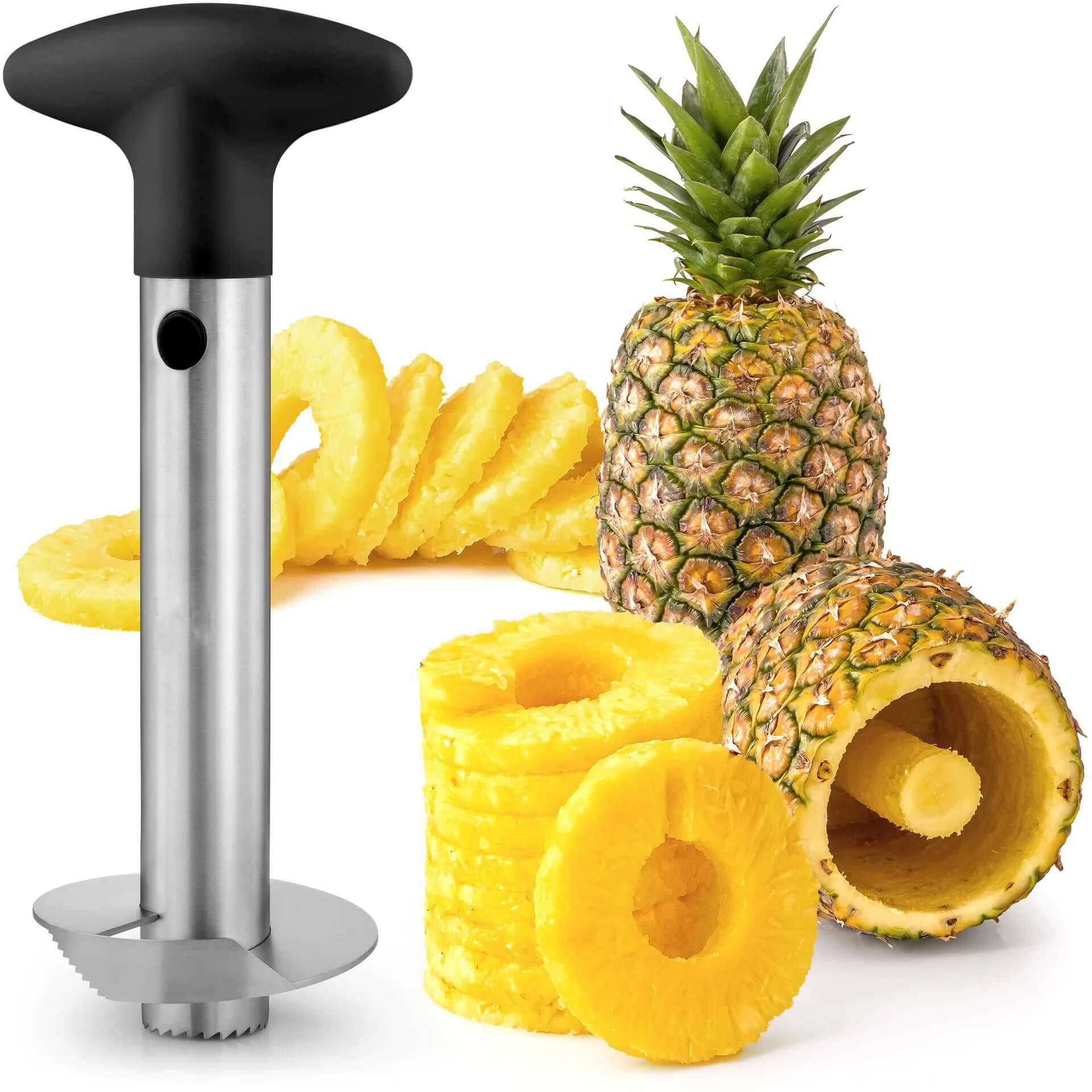Stainless steel pineapple peeler cutter with sliced pineapple rings and whole pineapple in the background.