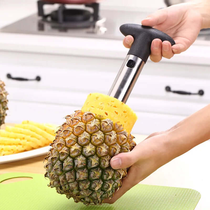 Stainless steel pineapple corer cutter in use, easily slicing pineapple for quick preparation in the kitchen.