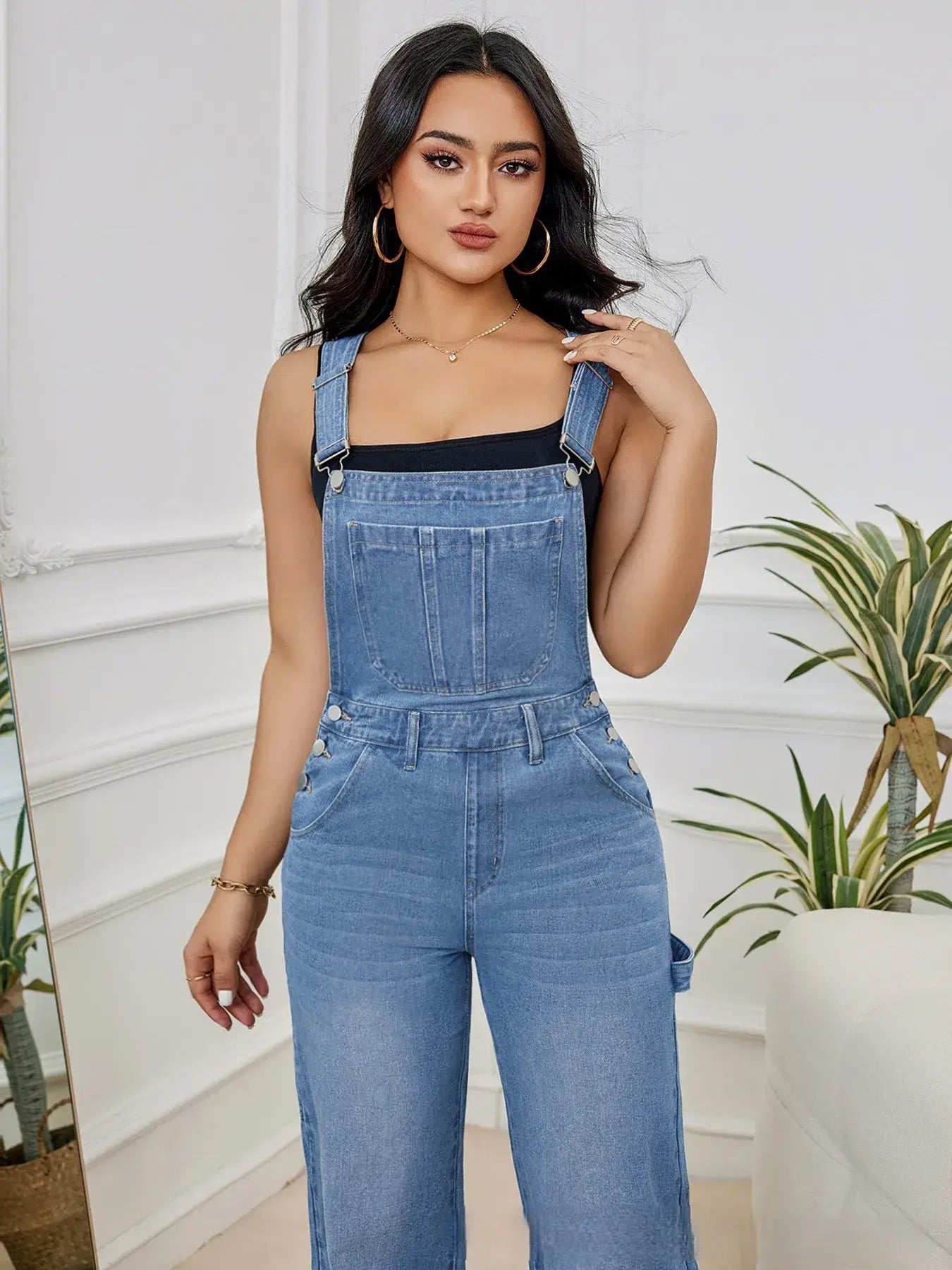 Chic Women's Denim Bib Jumpsuit with adjustable straps, perfect for layering and stylish everyday wear.