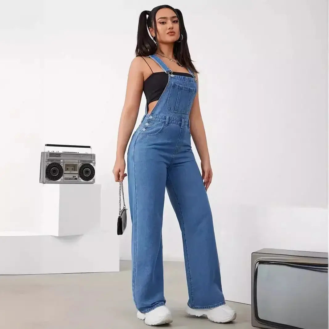 Women's denim bib jumpsuit with adjustable straps and sleeveless design, styled with retro accessories.
