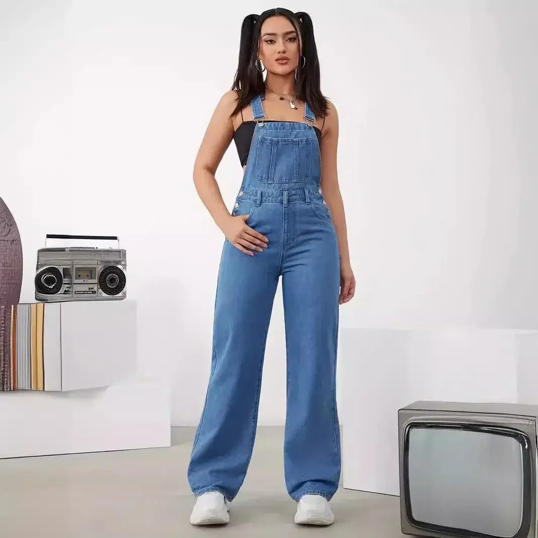 Model wearing a Women's Denim Bib Jumpsuit with adjustable straps and a sleeveless design, styled for a playful look.