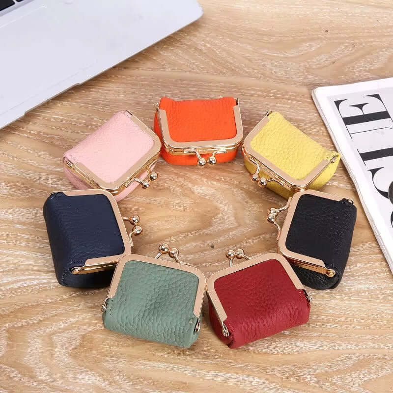 Colorful mini PU leather coin wallets in various shades arranged on a wooden table, showcasing a modern design.