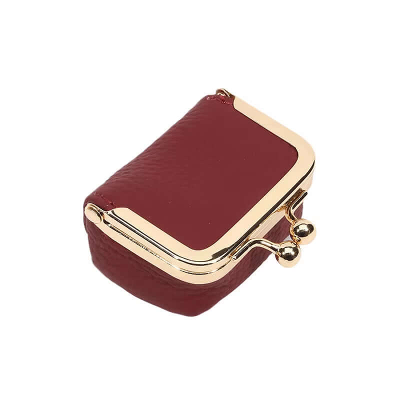 Mini red PU leather kiss lock jewelry box for storing rings, necklaces, and earrings.