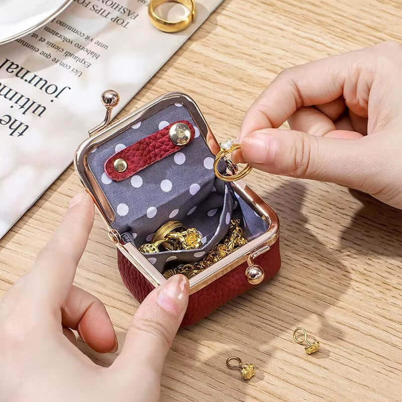 Mini PU leather jewelry box with ring, earrings, and necklace storage, featuring polka dot interior and kiss lock clasp.