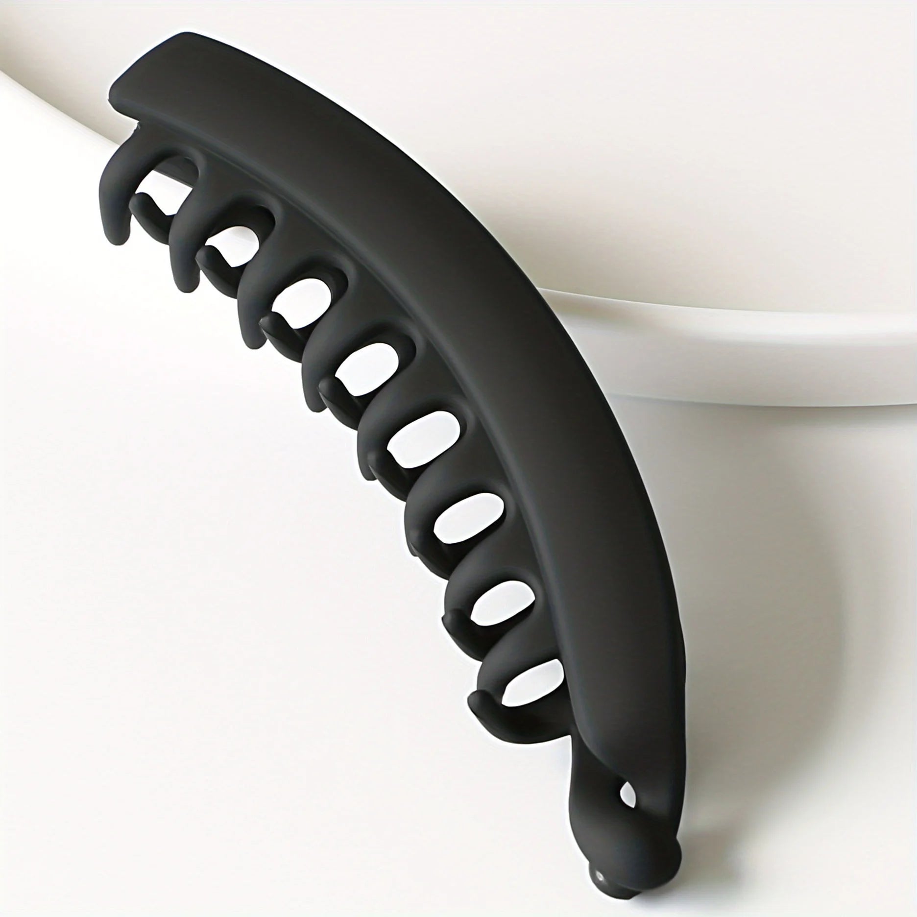 Matte black banana clip hair accessory for women, perfect for ponytails and hairstyles.