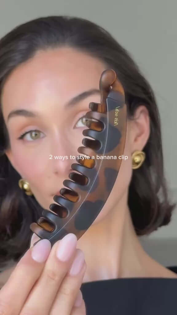 Woman showcasing a matte banana hair clip with styling tips in a fashionable hairstyle.